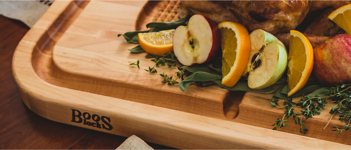 john boos carving board with fresh fruits on herb bed