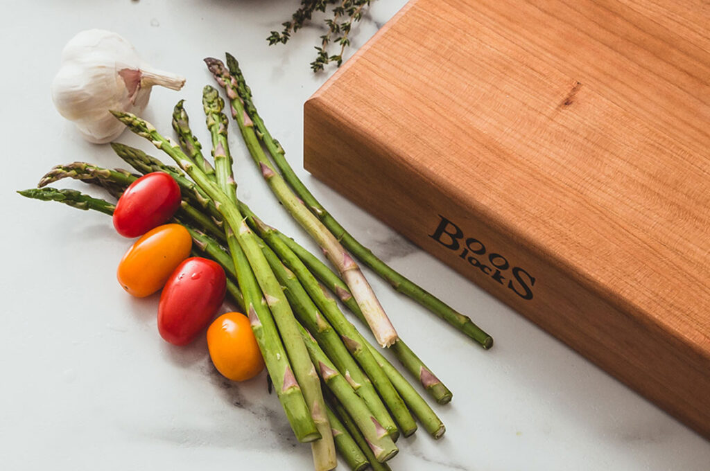 Boos Block and fresh vegetables on marble countertop