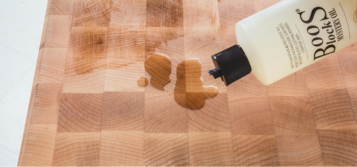 applying Boos Block mystery oil to a butcher block